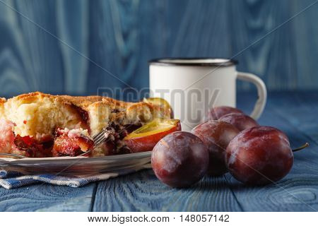 slice of bavarian plumcake on blue background