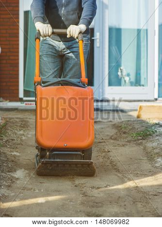 Vibratory plate compactor to make the soil flat before paving