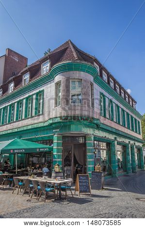 BIELEFELD, GERMANY - SEPTEMBER 6, 2016: Historical cafe Kachelhaus with people enjoying the sun in Bielefeld, Germany