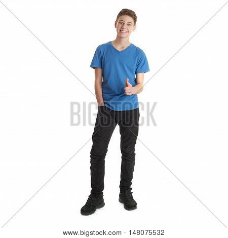 Cute teenager boy in blue T-shirt standing and poinitng forward over white isolated background full body