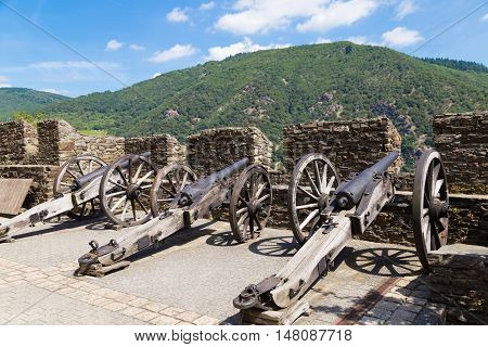Reichenstein Castle Rhine Valley Germany - UNESCO World Heritage - ancient cast iron cannon on roof against green hills