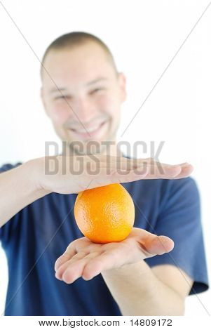 man holding orange in hand