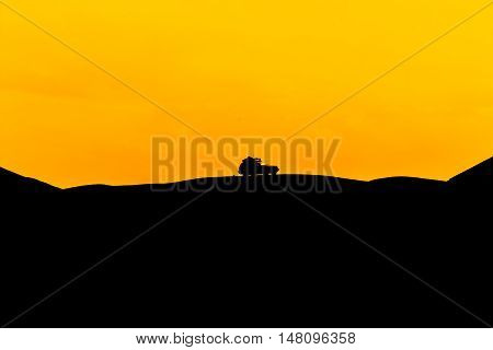 Car silhouette which off-road in the mountainous area.
