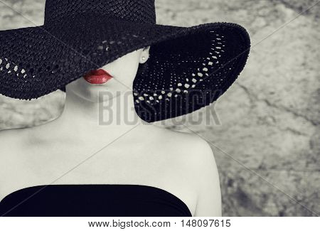 Fashion photo of beautiful lady in elegant black hat