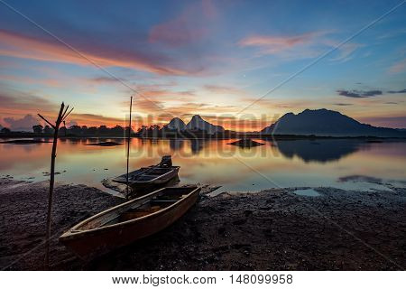 Beautiful Majectic Sunrise By The Lakeside With Fishing Boats. Nature Landscape.