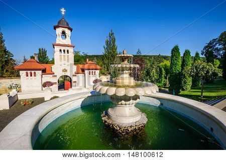 Fountain and entrance gates with bell tower, at Curchi Orthodox Christian Monastery, Moldova