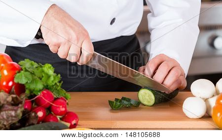 Chef cutting fresh and delicious vegetables for cooking