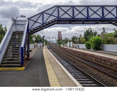 Overbridge at the train station with railtrack leading to the Forth Rail Bridge in Edinburgh, Scotland