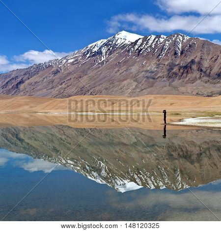 An unidentified photographer walking on Thatsang Karu lake in Ladakh, Jammu and Kashmir State of India