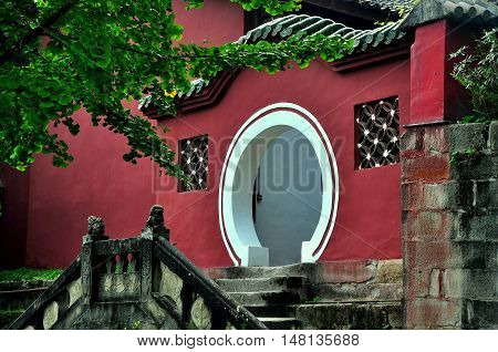 Langzhong Ancient City China - October 22 2013: A classic Chinese moongate leads to the tomb of legendary ruler Zhangfei at the historic Huanzhou Temple *