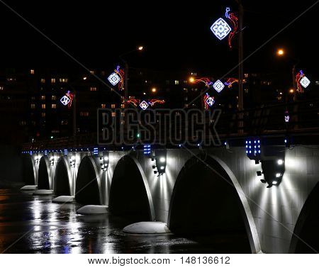 Lit new bridge across the river in the city