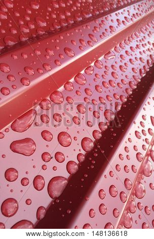 Water drops on a red roof after a heavy rain