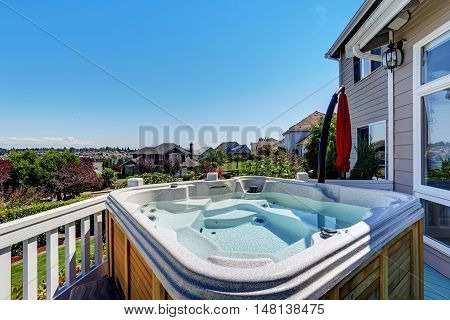 Close-up Of Wooden Hot Tub. Luxury House Exterior.