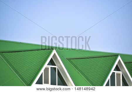 The House With Plastic Windows And A Green Roof Of Corrugated Sheet