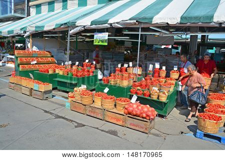 MONTREAL QUEBEC CANADA 09 16 2016: People buy groceries at Jean-Talon Market is a farmer's market in Montreal. Located in the Little Italy district, the market is bordered by Jean-Talon Street