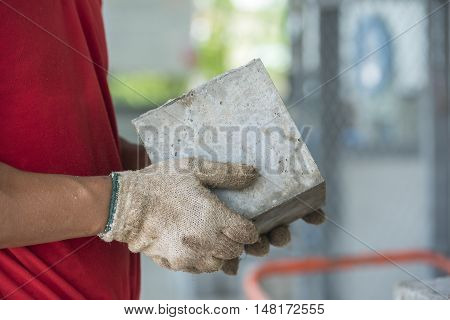 Technician checking of concrete quality during cube demolition