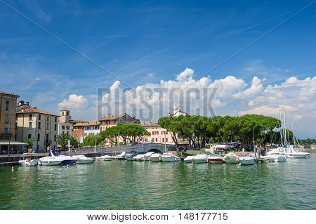 Desenzano, Lombardy, northern Italy, 15th August 2016: Small yachts and boats in harbor of Desenzano del Garda, lake Garda, Italy