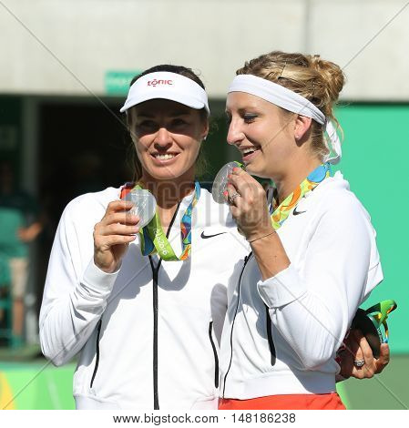 RIO DE JANEIRO, BRAZIL - AUGUST 14, 2016: Silver medalists team Switzerland Timea Bacsinszky (L) and Martina Hingis during medal ceremony after tennis women's doubles final of the Rio 2016 Olympics
