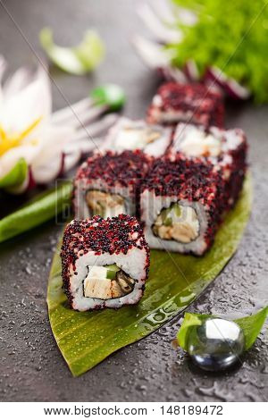 Maki Sushi - Roll made of Cream Cheese, Tamago, Cucumber and Smoked Eel inside. Red and Black Tobiko outside