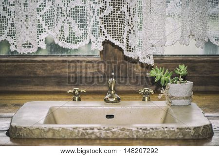 Macro pictures of antique sink with and green flower