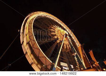 The high ferry wheel at the Oktoberfest in Munich at night