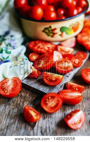 Tomato on wooden table. Freshly Picked red Tomatoes. Variation of tomatoes on wooden surface. Vegetables in the section. Harvesting. Healthy food from the garden.