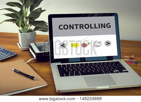 CONTROLLING Laptop on table. Warm tone businessman working