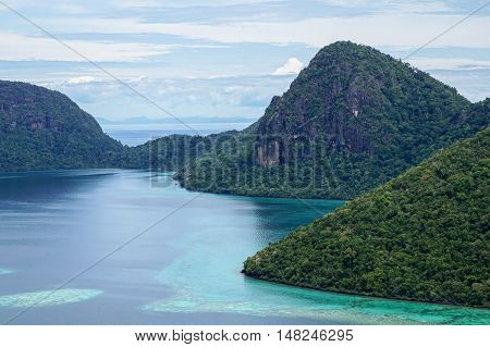 View of islands from top of Bohey Dulang island near Sipadan Island,Sabah.Mirror smooth ocean surrounded by mountains.The bright blue water & rocky shore in the tropical island of Semporna,Borneo