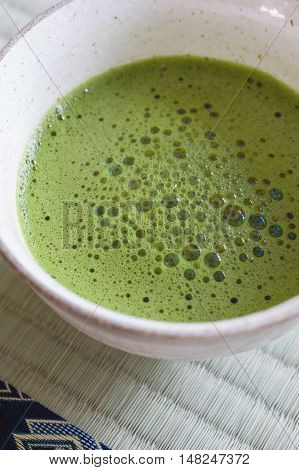 Japanese Matcha green tea in a chawan or traditional ceramic bowl shot with shallow focus