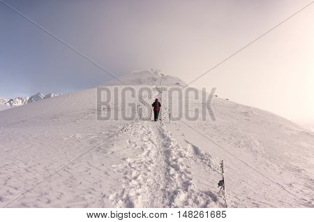 Beautiful winter mountain landscape. Single man on the ridge. Tatry