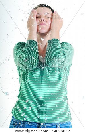 bautiful young woman wash face with clean water isolated on white in studio