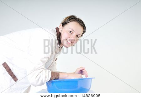 bautiful young woman wash face with clean water isolated on white in studio
