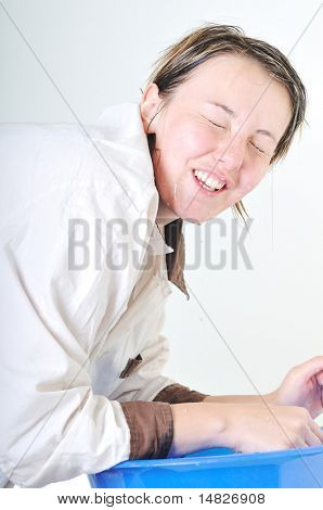 bautiful young woman wash face with clean water isolated on white in studio