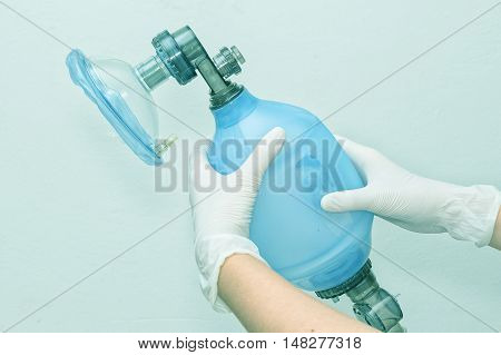 Doctor holding breathing bag (Ambu) and face mask
