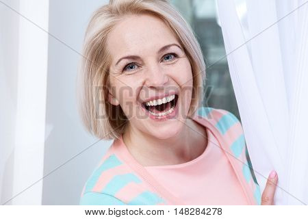 Attractive middle aged woman relaxing at home. The beautiful face close up.
