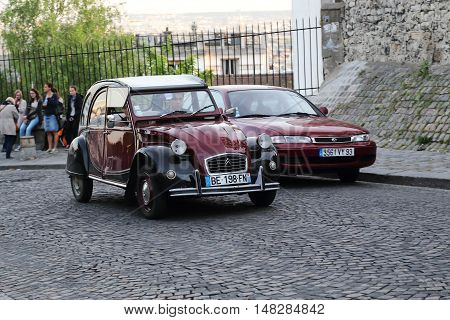 PARIS, FRANCE - MAY 12, 2015: It is an old Citroen Citroen 2 CB the legend of the French car industry on the cobbled steets of Montmatre.