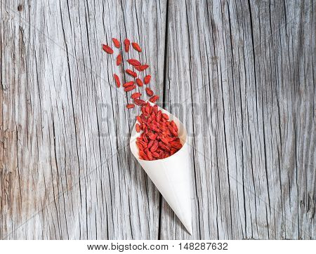 Goji berries on wood rustic background, closeup