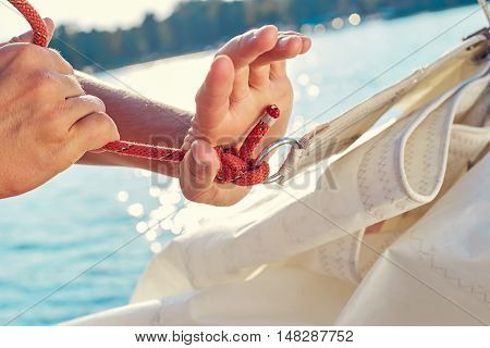 User knitting knots. Bowline knot. Process of tying Bowline process is a top view on the sail.