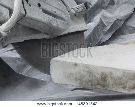 Stone sawing with a circular saw while renovation of a town