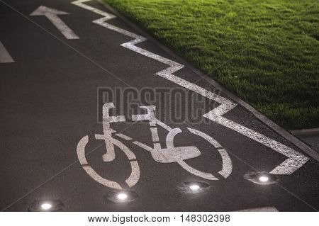 The bicycle sign on the grey road in the public park for biking
