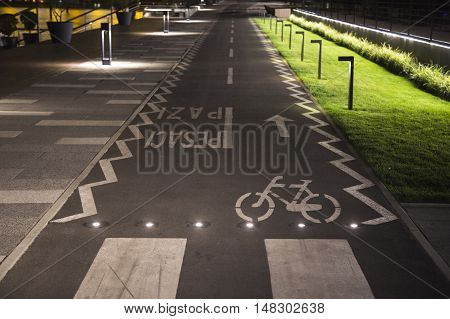 The bicycle sign on the grey road in the public park for biking