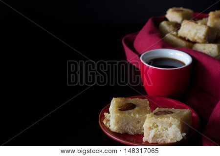Basbousa and Coffee with Dark Background Horizontal with Copy Space
