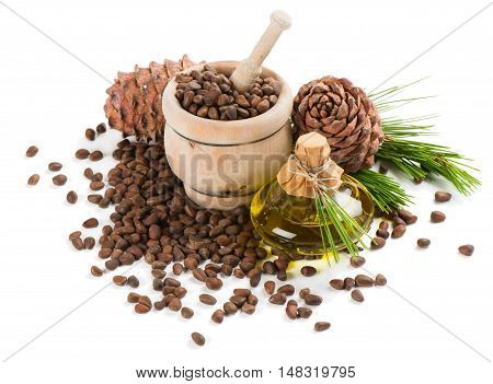 Cedar pine nuts in a mortar cones oil cedar brunch isolated on white background.