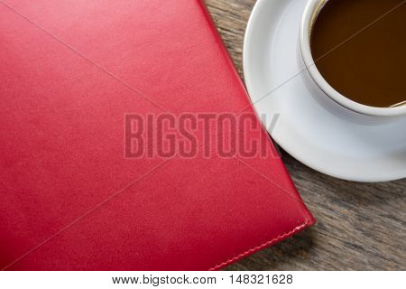 notebook and cup of coffee on the desk