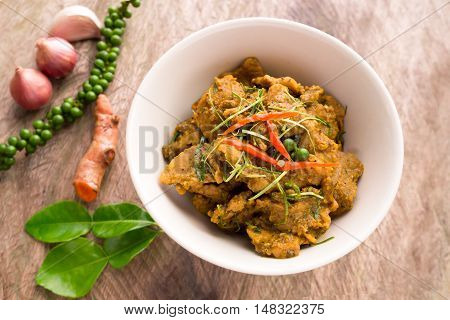 Hot and spicy pork curry traditional local Thai food with herbs pepper turmeric chili onion and kaffir lime leaves. Delicious and famous Thailand food.