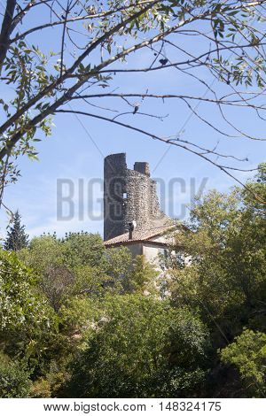 Antique Tower Made Of Stone Surrounded Of Trees In Lagrasse, France