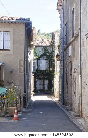 Narrow Street With Houses With Ivy In Lagrasse, France
