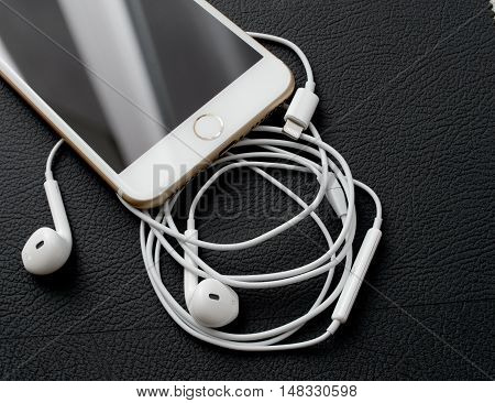 PARIS FRANCE - SEP 16 2016: New Apple iPhone 7 Plus unboxing in the first day of sales - Lighting audio conector and earpods. New Apple iPhone acclaims to become the most popular smart phone in the world in 2016