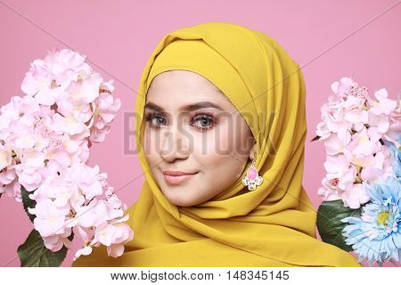muslimah model in fashionable dress isolated in pink background