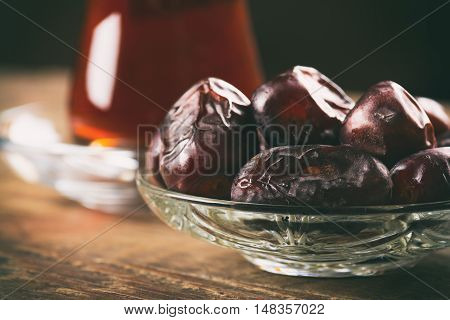 Tea with dates on wooden table. Selective focus